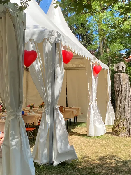 Luftballons in Herzform hängen an einem Pavillon